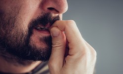 Closeup of man biting his nails