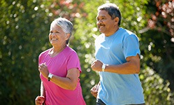 Couple smiling while jogging in park