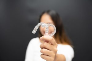 woman with two clear aligners 